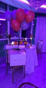 a table with a bunch of pink and purple balloons at jawharat alshlal Establishment in Hafr Al Baten