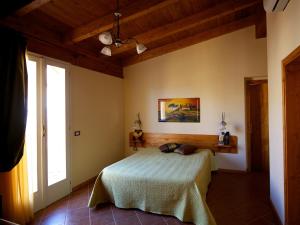 a bedroom with a bed and a window at Olympo in Bisceglie