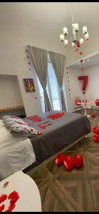 um quarto com uma cama grande com decorações vermelhas no chão em Relais del Corso em Manfredónia