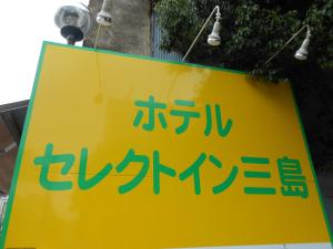 a yellow sign with chinese writing on it at Select Inn Mishima in Mishima