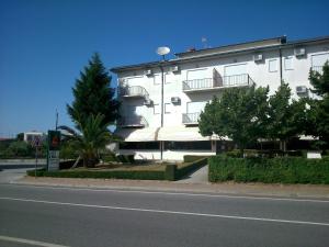 a white building with balconies on the side of a street at A Muralha in Almeida