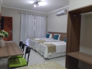 En eller flere senge i et værelse på Hotel Cantinho Verde