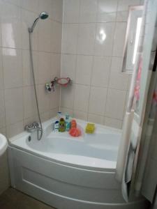 a bath tub in a bathroom with a shower at apartament Ramnicu Valcea in Râmnicu Vâlcea