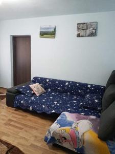 a living room with a couch and a bed at apartament Ramnicu Valcea in Râmnicu Vâlcea