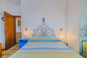 a bedroom with a large bed with a blue dresser at Trilocale Naldina a Marciana Marina in Marciana Marina