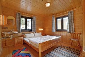a bedroom with a large bed in a wooden room at Haus Gerdi in Söll