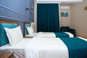 Voodi või voodid majutusasutuse Legend Hotel toas