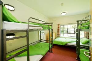 a room with two bunk beds and a window at YHA Ironbridge Coalport in Coalport
