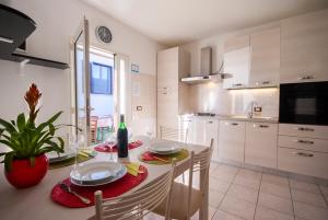 a kitchen with a table and chairs and a dining room at Appartamenti L'Arcipelago in Marina di Campo +45 photos