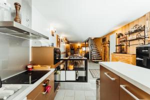 a large kitchen with wooden cabinets and a staircase at Farmhouse with 4 bedrooms 4 bathrooms parking sauna terrace and garden in Chamonix