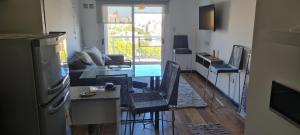 a kitchen and living room with a table and chairs at BALCÓN AL RíO PARANÁ in Paraná