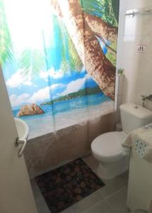 a bathroom with a painting on the shower curtain at City Hall House in Volos
