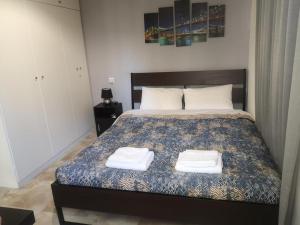 a bedroom with a bed with two towels on it at City Hall House in Volos