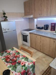 a kitchen with a table and a white refrigerator at City Hall House in Volos