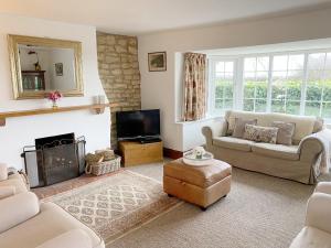 a living room with a couch and a fireplace at Grange Farm Cottage in Sleaford