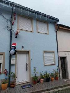 a blue house with a santa claus character on the side of it at Alto da lapa Luxury house in Porto