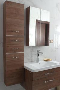 a bathroom with a sink and a mirror at jawharat alshlal Establishment in Hafr Al Baten