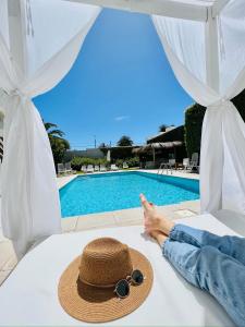 a woman laying on a bed with a straw hat at Atlántico Boutique Hotel in Punta del Este