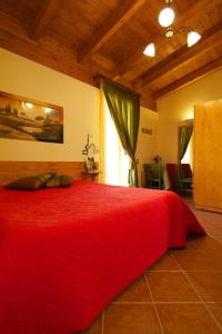 a large red bed in a room with a window at Olympo in Bisceglie
