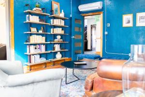 a living room with blue walls and a table and chairs at 11th Avenue Hostel in Denver