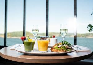 a table with a plate of food and drinks at Viking Line ferry Gabriella - One-way journey from Helsinki to Stockholm in Helsinki