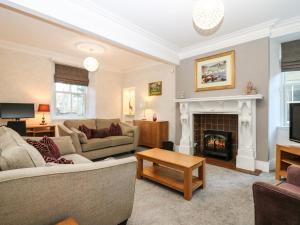 a living room with a couch and a fireplace at Mavisbank in Peterhead