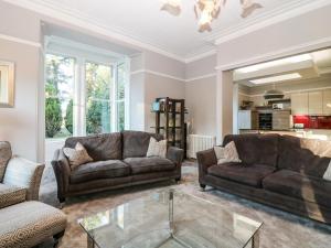 a living room with two couches and a glass table at Mavisbank in Peterhead