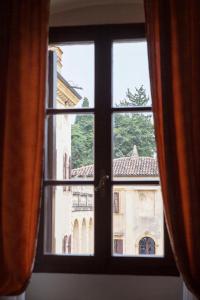 a window with a view of a building at Hotel Villa Giona in San Pietro in Cariano