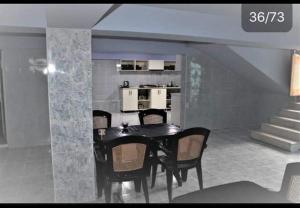 a dining room with a table and chairs and a kitchen at Rio Gonio in Gonio +77 photos