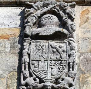 un relief en pierre sur le côté du bâtiment dans l'établissement La Posada de Maria, à Villanueva de la Peña