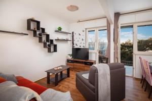 Televízia a/alebo spoločenská miestnosť v ubytovaní Beach Apartment Milena