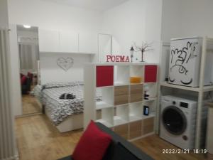 a room with a bedroom with a bed and a speaker at Poema Apartment in Casalecchio di Reno