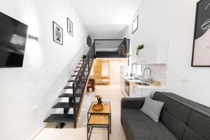 a living room with a couch and a stair case at Cohens apartments in Jerusalem