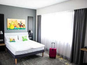 Posteľ alebo postele v izbe v ubytovaní ibis styles Grudziadz