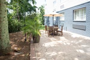 a patio with an umbrella and a table and chairs at Candlewood Suites Charleston – Mt. Pleasant by IHG in Charleston