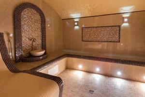 a large bathroom with a tub and a sink at Sofa Boutique Hotel & SPA in Sumy