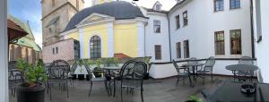 un patio al aire libre con mesas y sillas y un edificio en Hotel Vacek Pod Věží, en Hradec Králové