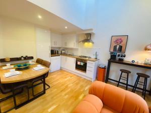 a kitchen and living room with a table and chairs at 2 Bed 2 bath with Private Parking in Edinburgh