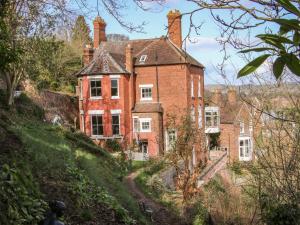 an old red brick house on a hill at Riverview Apartment in Bridgnorth