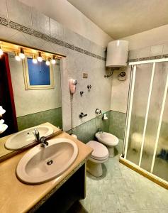 a bathroom with a sink and a toilet and a shower at Il Muretto in Marettimo +23 photos