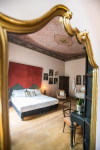 a bedroom with a large bed and a mirror at Soprarno Suites in Florence