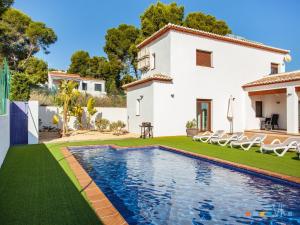 a villa with a swimming pool in front of a house at VH CostaBlanca - PINETS in Benissa