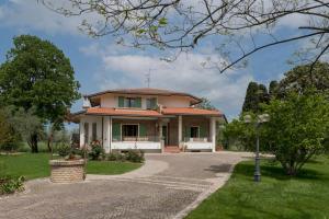 a house with a pathway in front of it at Villa Barbara in San Giovanni in Marignano