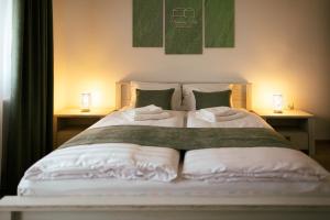 A bed or beds in a room at Munkácsy Villa - Szekszárd