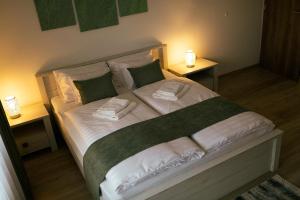 A bed or beds in a room at Munkácsy Villa - Szekszárd