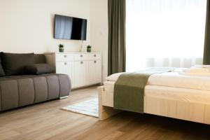 A bed or beds in a room at Munkácsy Villa - Szekszárd