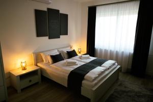 A bed or beds in a room at Munkácsy Villa - Szekszárd