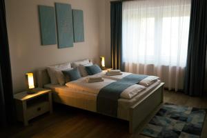 A bed or beds in a room at Munkácsy Villa - Szekszárd