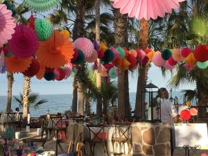 a group of colorful umbrellas hanging over a beach at Hotel Rancho Buenavista in Los Barriles +183 photos