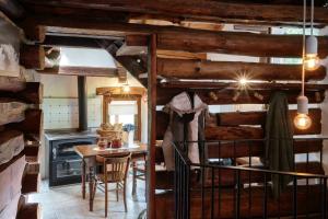 a kitchen with wooden walls and a table and a stove at HelloChalet - Chalet da MiRo - Sunny terraces with stunning Matterhorn views, reachable on foot only in Valtournenche